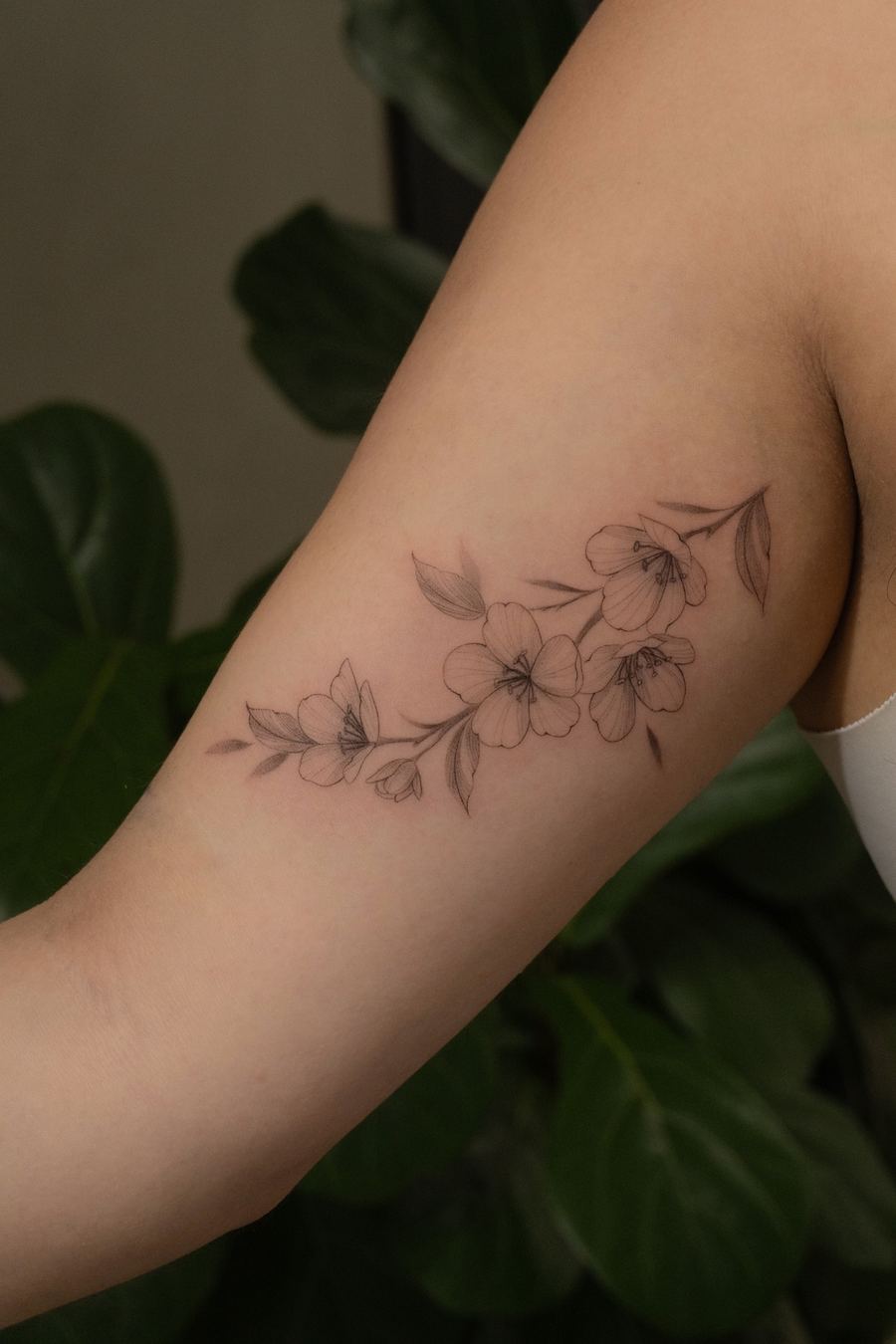 Fine line cherry blossom branch tattoo, inner arm